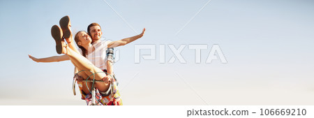 Banner. Poster. Portrait of happy, funny young active couple riding one bicycle. Lovely riders enjoying themselves. Romantic relationships. Banner. Poster. Portrait of happy, funny young active couple riding one bicycle. Lovely riders enjoying themselves. Romantic relationships. 106669210