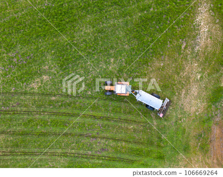 aerial view of tractor , combine cultivating field. drone shot. picture with space for text aerial view of tractor , combine cultivating field. drone shot. picture with space for text 106669264