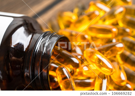 Fish oil Omega 3 capsules vitamin with EPA and DHA isolated on white background. Fish oil Omega 3 capsules vitamin with EPA and DHA isolated on white background. 106669282
