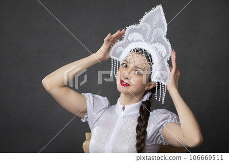 Snow Maiden. Winter portrait of a beautiful young woman in a winter crown. 106669511