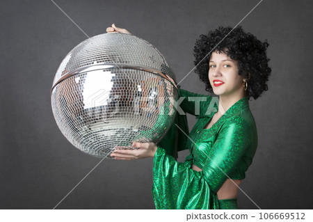 Happy girls in disco style, with disco ball, halloween party, on gray background. 80s themed party. 106669512