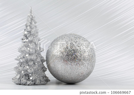 Christmas or New Year background with silver snowy tree and silver transitional decoration. Bright festive background. 106669667