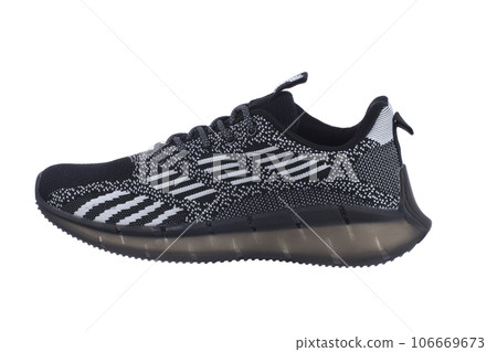 Black rag sneaker with gray stripes on a white background. Black rag sneaker with gray stripes on a white background. 106669673