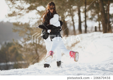 Family on family Christmas vacation. Woman and little girl in a forest. People walks. 106670438