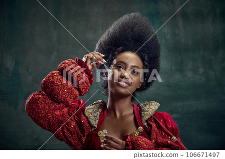 Skincare and cosmetology. Beautiful african woman, princess using face serum against vintage green background 106671497