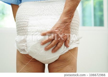 Asian senior woman patient wearing adult incontinence diaper pad in hospital. Asian senior woman patient wearing adult incontinence diaper pad in hospital. 106672966