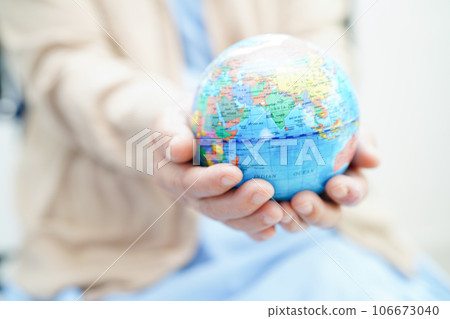 Bangkok, Thailand April 1, 2023 Asian elderly woman patient holding globe in hand at hospital. Bangkok, Thailand April 1, 2023 Asian elderly woman patient holding globe in hand at hospital. 106673040
