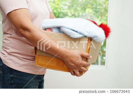 Clothes donations in cardboard box for volunteer. Clothes donations in cardboard box for volunteer. 106673043