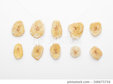 Single dried dehydrated banana chips isolated on white background.Macro 106673738