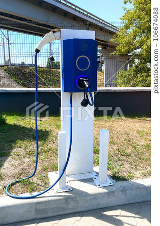 Eco friendly transport concept. Electric charging station in city. Vertical view. Eco friendly transport concept. Electric charging station in city. Vertical view. 106674088