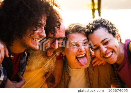 Happy young group of multiracial best friends having fun together outdoors. Millennial diverse Happy young group of multiracial best friends having fun together outdoors. Millennial diverse 106674095