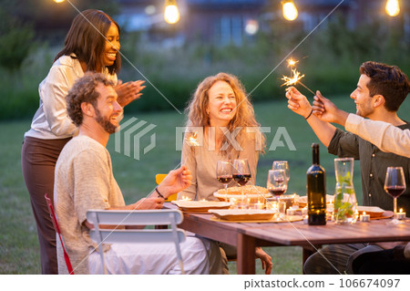 Birthday Bliss: Multiracial Friends Celebrate Under Garden Lights 106674097