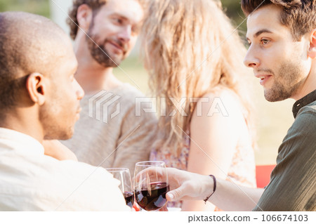 Romantic Evening Sparks at Multiracial Garden Party Romantic Evening Sparks at Multiracial Garden Party 106674103