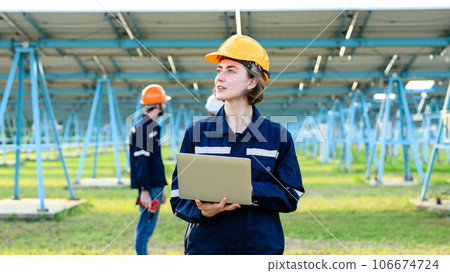 Engineers team working together at solar power station 106674724