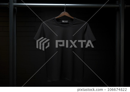 A mock-up of a black T-shirt is hanging on a hanger A mock-up of a black T-shirt is hanging on a hanger 106674822