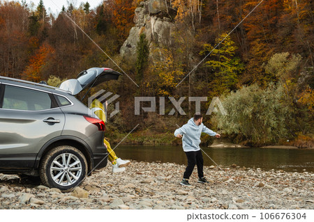 couple road trip travelers resting near mountain river autumn season 106676304