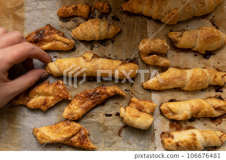 home made pastry in hand and on a baking tray home made pastry in hand and on a baking tray 106676481