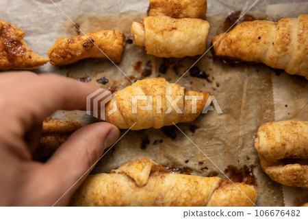 home made pastry in hand and on a baking tray 106676482