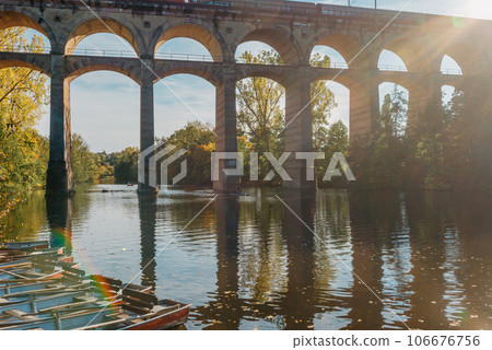 Railway Bridge with river in Bietigheim-Bissingen, Germany. Autumn. Railway viaduct over the Enz River, built in 1853 by Karl von Etzel on a sunny summer day. Bietigheim-Bissingen, Germany. Old 106676756