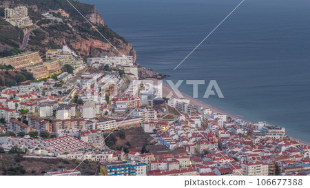 Aerial view of the coastline of the village of Sesimbra day to night timelapse. Portugal Aerial view of the coastline of the village of Sesimbra day to night timelapse. Portugal 106677388