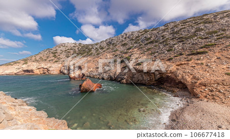 An abandoned rusty ship in the sea timelapse near huge rock formations in Navagio Beach, Amorgos Island, Greece 106677418
