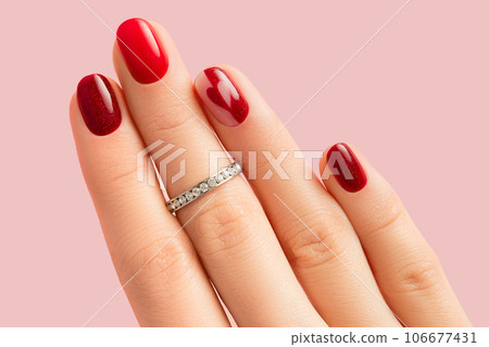 Female hand with manicure on pink background 106677431