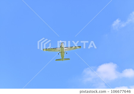 Light aircraft flying in the sky 106677646