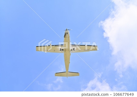 Light aircraft flying in the sky 106677649