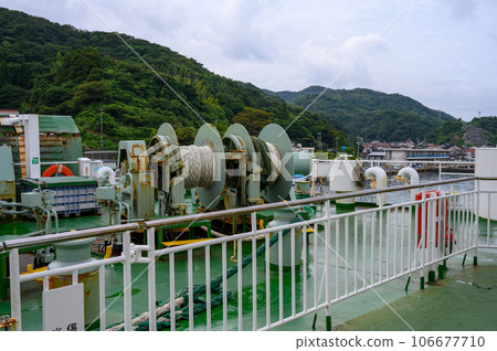 Mechanical devices on the rear deck of a car ferry 106677710