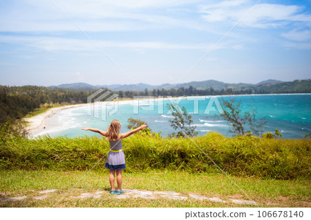 Child hiking. Sea and mountain view. Kids hike. 106678140
