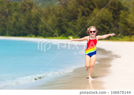 Kids playing on beach. Children play at sea. 106678144