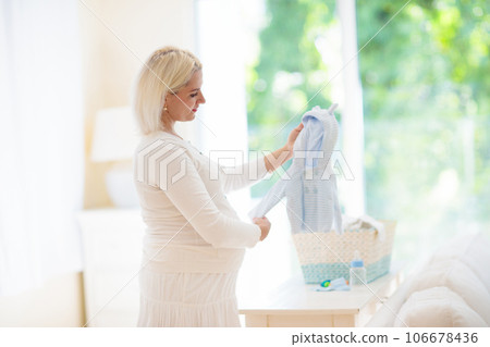 Pregnant woman at home. Young expecting mother. Pregnant woman at home. Young expecting mother. 106678436