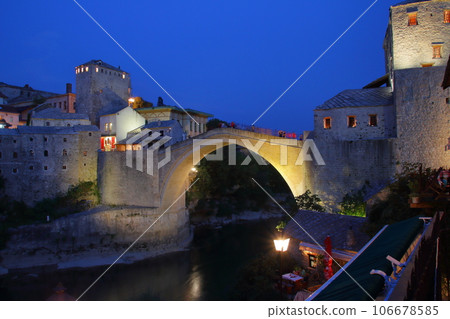 Mostar, Bosnia and Herzegovina, Southern Europe - Night view of Stari Most, a world cultural heritage bridge over the Neretva River, and the old town Mostar, Bosnia and Herzegovina, Southern Europe - Night view of Stari Most, a world cultural heritage bridge over the Neretva River, and the old town 106678585