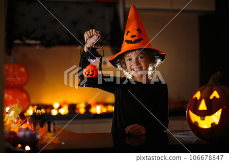 Family decorating home. Halloween arts and crafts. 106678847