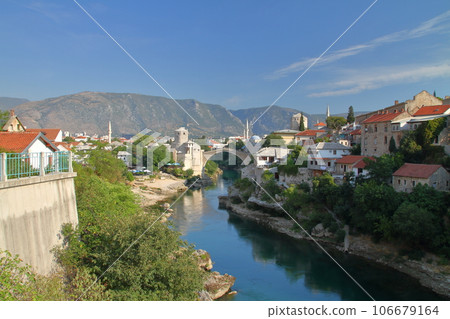 Mostar, Bosnia-Herzegovina, Southern Europe, Stari Most, a World Cultural Heritage bridge over the Neretva River, and a view of the mountains 106679164