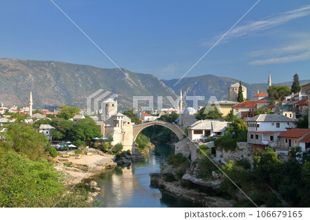 Mostar, Bosnia-Herzegovina, Southern Europe, Stari Most, a World Cultural Heritage bridge over the Neretva River, and a view of the mountains Mostar, Bosnia-Herzegovina, Southern Europe, Stari Most, a World Cultural Heritage bridge over the Neretva River, and a view of the mountains 106679165