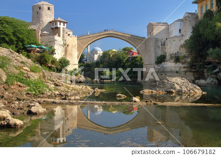 Stari Most, a world cultural heritage bridge spanning the Neretva River in Mostar, Bosnia and Herzegovina, southern Europe, and the water mirror on the river surface 106679182