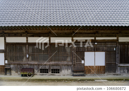 A cart placed in front of an old building A cart placed in front of an old building 106680872