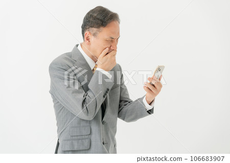 Business man who has trouble looking at his smartphone 106683907