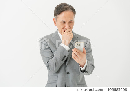 Business man who has trouble looking at his smartphone Business man who has trouble looking at his smartphone 106683908