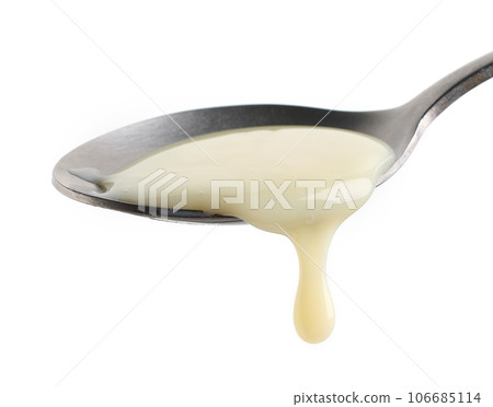 condensed milk in a spoon 106685114