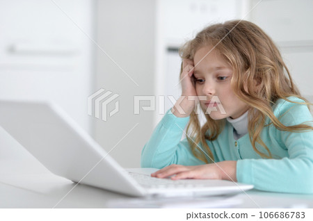 Cute and happy little girl children using laptop computer Cute and happy little girl children using laptop computer 106686783