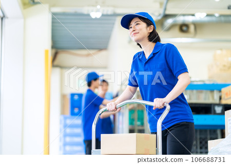 Young female worker shipping luggage at warehouse 106688731