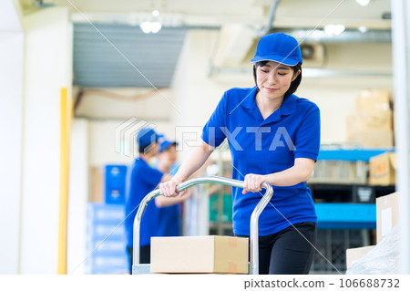 Young female worker shipping luggage at warehouse Young female worker shipping luggage at warehouse 106688732