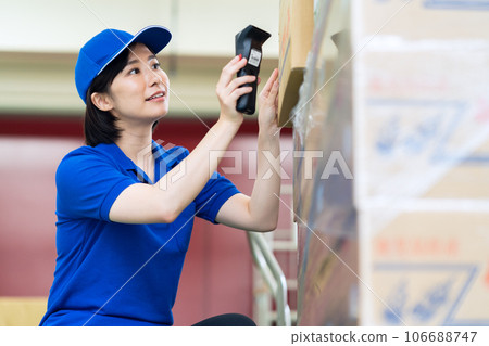 Young female worker shipping luggage at warehouse Young female worker shipping luggage at warehouse 106688747