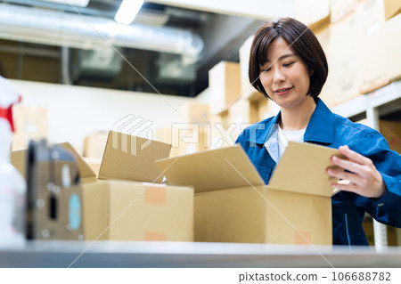 Young female worker shipping luggage at warehouse Young female worker shipping luggage at warehouse 106688782