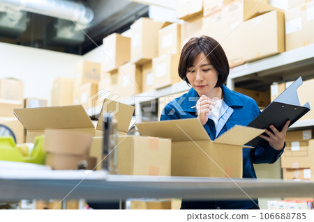 Young female worker shipping luggage at warehouse 106688785