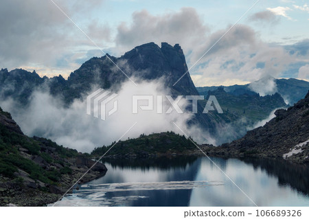 Tranquil meditative mood scenery of glacial lake with pointy fir Tranquil meditative mood scenery of glacial lake with pointy fir 106689326