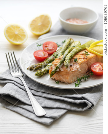 Baked Delicious salmon, green asparagus on  plate 106689762