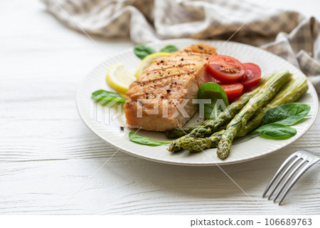 Baked Delicious salmon, green asparagus on plate Baked Delicious salmon, green asparagus on plate 106689763